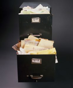 Document Management Toronto - File cabinet overloaded with documents and files